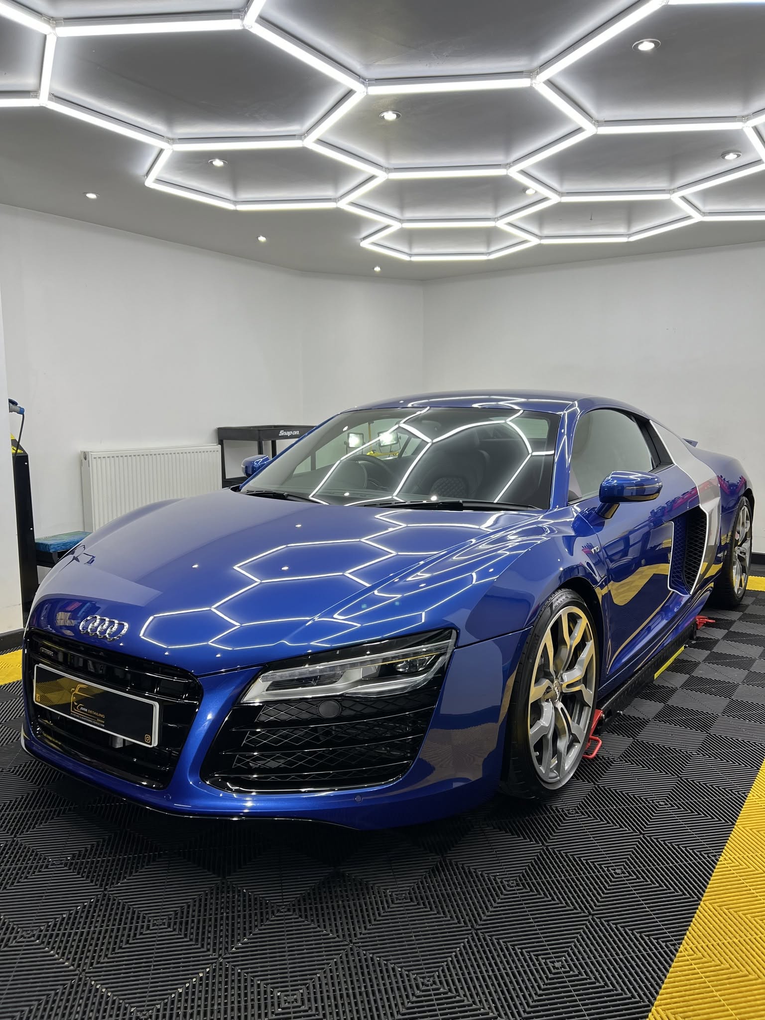 Blue Audi R8 with polished paintwork in the studio