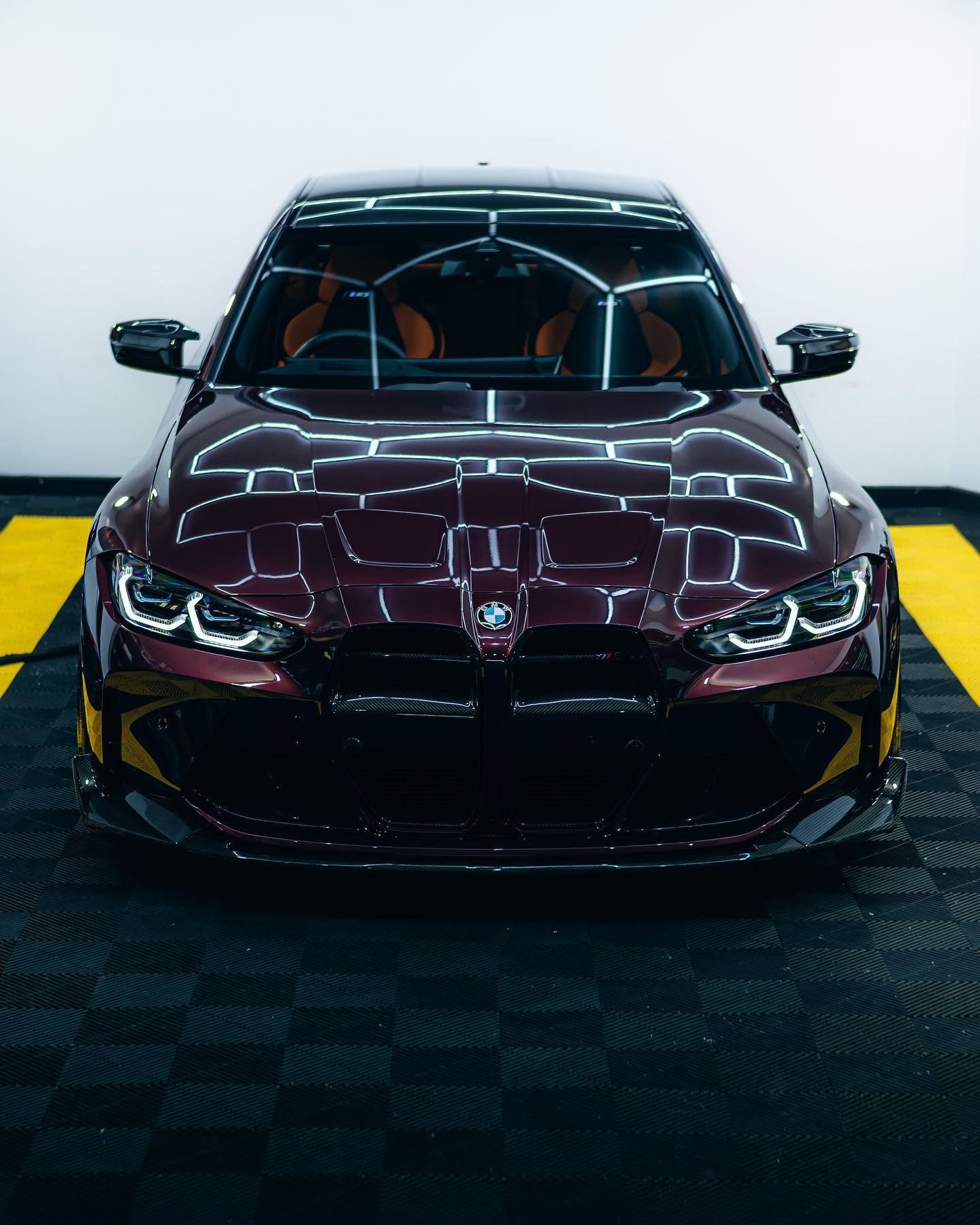 Front view of a BMW M with reflective burgundy paintwork