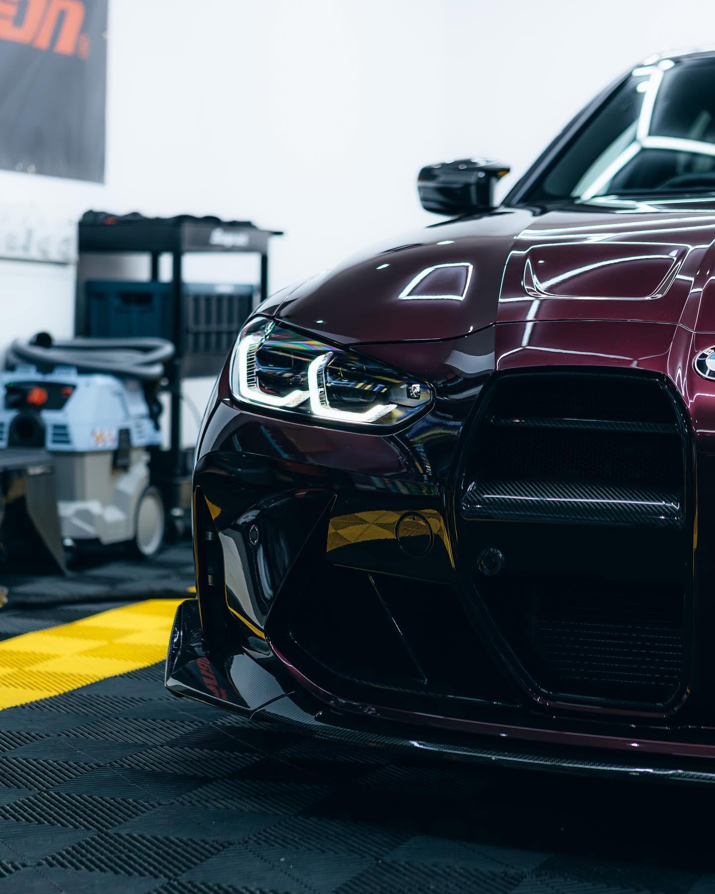 Close-up of a BMW M headlight and polished paintwork