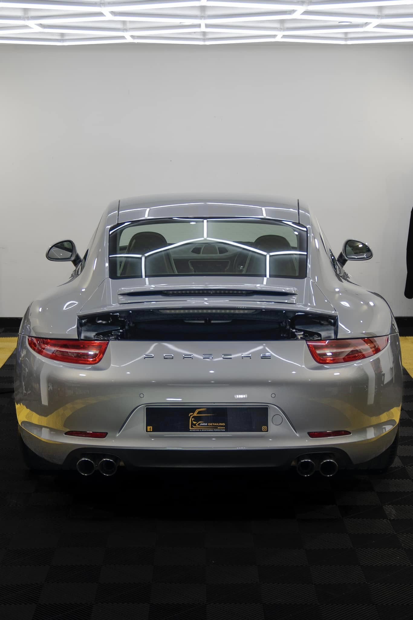 Rear view of a silver Porsche with polished paintwork