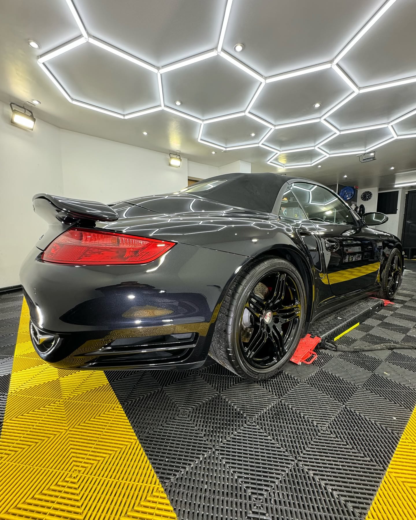 Rear view of a black sports car with a detailed finish