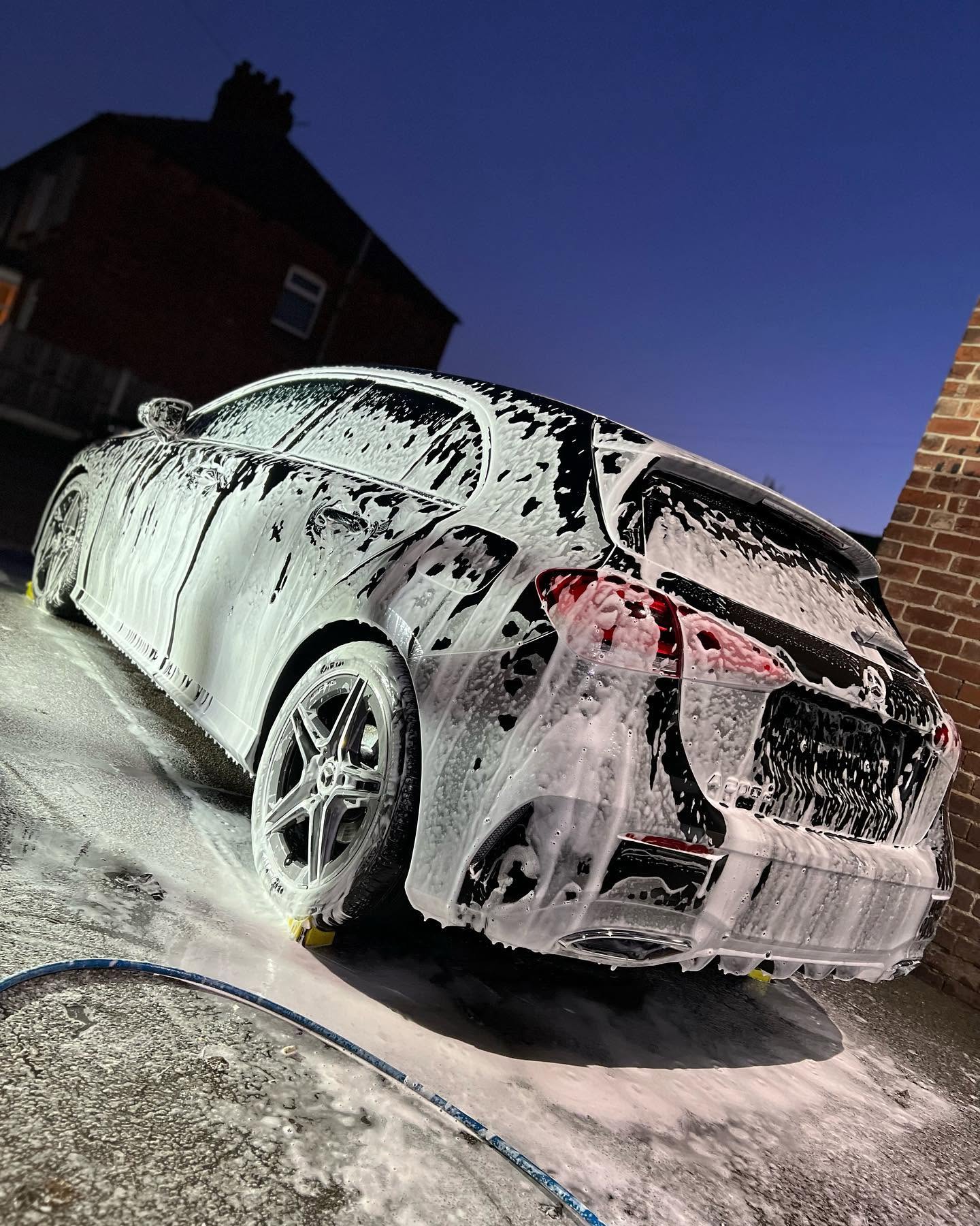 Vehicle covered in snow foam during the pre-wash stage