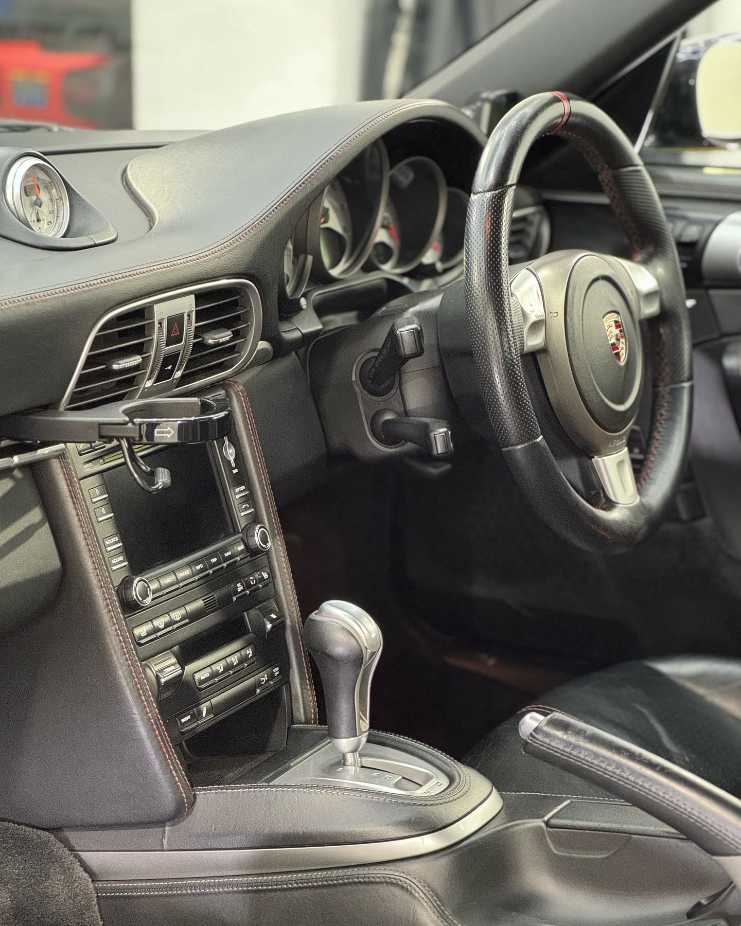 Detailed Porsche interior with clean dashboard and centre console